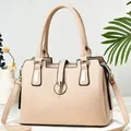 Detail of beige soft leather handbag with gold hardware and spacious multi-layered zippers - Light Khaki