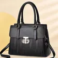 Elegant black embossed striped handbag with golden letter clasp and shoulder strap - Black
