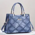 Blue denim quilted tote bag with large diamond stitching and metallic top handles - Dark Blue