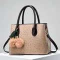 Ostrich texture handbag in beige with dark brown handles and cherry fur ball pendant - Khaki