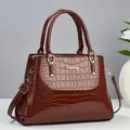 Elegant wine red crocodile pattern leather handbag with gold metal hardware and strap - Brown