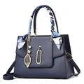 Navy blue lychee leather handbag with decorative silk scarf and golden leaf pearl charm - Dark Blue
