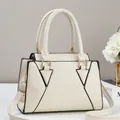 Detail of off-white lychee texture handbag with black geometric lines and gold hardware - Off White