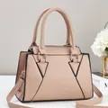 Detail of powder pink tote bag with lychee grain leather and black contrast piping - Apricot
