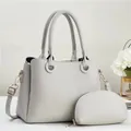 Detail showing litchi grain texture on grey tote bag with gold-tone hardware and straps - Two-piece Set (Main Bag + Coin Purse) / Light Gray