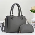 Detail of dark grey lychee leather tote bag with matching zipper pouch and gold hardware - Two-piece Set (Main Bag + Coin Purse) / Dark Gray