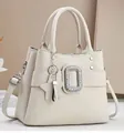 Beige faux leather handbag with rhinestone buckle and star pendant accessory - Off White