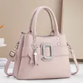 Pink lychee texture crossbody bag featuring a rhinestone buckle and star charm - Purple