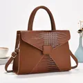 Détail d'un sac à bandoulière marron en patchwork avec textures litchi et crocodile - Jaune Terre