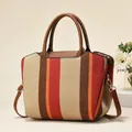 Close-up of woven vertical stripes in red orange and brown on a large canvas tote bag - Wine Red