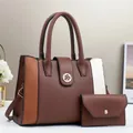 Detail view of large-capacity three-color patchwork leather handbag with gold floral lock - Coffee