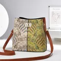 Detail of jacquard bucket bag showing ethnic pattern stitching and gold turn-lock closure - Khaki/Earth Yellow