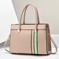 Vue détaillée du sac cabas beige structuré avec rayures verticales en cuir vert clair et métal - Kaki