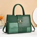 Detail of green tote bag with crocodile texture and gold FEI&CHI metal buckle - Green