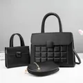 Detailed close-up of a 3-piece black pebble leather handbag set with quilted texture - Black