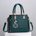 Dark green tote bag with embossed triangle texture and golden clover pearl charm - Green