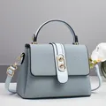 Detail of woven texture flap bag with gold hardware and removable light blue strap - 24x10x16cm / Blue
