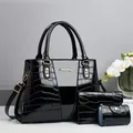 Close-up of a 3-piece black crocodile embossed patent leather handbag set and wallet - Black
