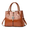 Brown glossy faux crocodile leather handbag with elegant metallic cat charm pendant - Khaki/Earth Yellow