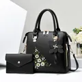 Elegant black embroidered daisy tote bag and matching clutch set with floral charm - Black