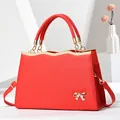 Red structured tote bag with gold bow accent and saffiano texture for women - Red