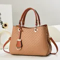 Detail of caramel brown woven texture shoulder bag with gold metal buckle and leather handle - Khaki