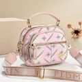 Pink and light blue color block crossbody bag with floral print and wide strap - Pink