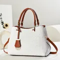 Close-up of woven texture and premium brown leather handle on the white shoulder bag - Pure White