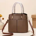 Chic brown textured leather bucket bag with top handles and adjustable shoulder strap - Coffee