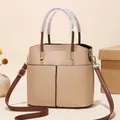 Beige and brown leather bucket bag with litchi texture and golden hardware accents - Khaki