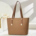 Detail of a brown tote bag with fine texture, golden hardware and slim shoulder straps - Dark Khaki