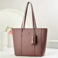 Detail of burgundy pebbled leather tote bag with brand logo and small detachable pouch - Purple