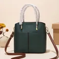Dark green bucket bag with pebbled leather texture and brown adjustable shoulder straps - Dark Green