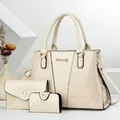 Detail view of snakeskin pattern leather on white three-piece fashion handbag set - Off White