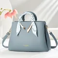 Chic blue leather tote bag for women with silk scarf handle and golden metal hardware - Blue
