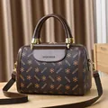 Brown Boston handbag in MQCKDE print with golden hardware and long shoulder strap - Coffee