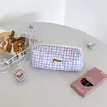 Detail of purple plaid pencil case featuring quilted texture and pink bow patterns - Purple Plaid