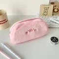 Close-up of pink plush pig pencil case with embroidery details on a minimalist desk - Pink Pig