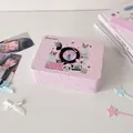 Detailed close-up of a pink vintage tin storage box with cute cat and retro prints - Gramophone