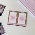 Close-up of a double-fold vintage brown photo frame keychain with star details and pink glow - Wings Photo Clip