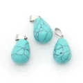Three-piece turquoise stone teardrop pendants with polished silver metal clasps on white - Blue Turquoise