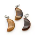Three crescent moon tiger eye stone pendants with silver metal bails on white background - Tiger's Eye