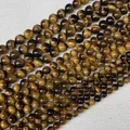Dettaglio di perle tonde in occhio di tigre naturale con lucentezza setosa e levigata - Occhio di tigre