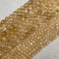 Detailed view of yellow crystal round beads in various sizes on grey linen background - Mini / Citrine