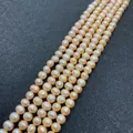 Lustrous 7-8mm peach pink natural freshwater potato pearl strands on a black mat - 12-13mm / Pink
