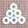 Detailed view of six flat donut opal stones with smooth finish on a natural texture background - Opal