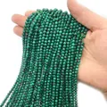 Faceted malachite gemstone beads in deep green with characteristic banded textures - Malachite
