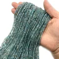 Strands of 2-3mm faceted natural blue-green gemstone beads held in hand for jewelry DIY - Apatite
