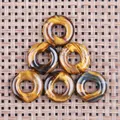 Polished natural tiger eye stone donut pendants with golden brown fibrous textures - Tiger's Eye