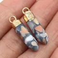 Hexagonal stone pendant in golden cap setting held in hand showing scale and detail - Grey Mixed Stone